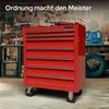 A red tool chest with seven drawers is shown in a workshop setting, with tools and equipment in the background. Produktbild-Vorschau