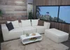 A modern living room setup with a modular white sofa, coffee table, and ottoman. Anteprima dell’immagine prodotto