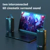 Two black portable speakers are placed next to an open laptop, with the laptop screen displaying a vibrant image of people at a party. The speakers have colorful LED lights at the bottom. Produktbild-Vorschau