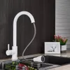 A white kitchen faucet with a pull-down sprayer is shown in a kitchen sink setting. Náhľad obrázku produktu