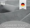 A close-up of soft, gray fabric, likely bedding, with branding and a German quality mark. Produktbild-Vorschau