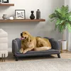 A golden retriever dog is resting on a dark gray pet sofa in a living room setting. Podgląd zdjęcia produktu