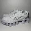 A pair of white Nike Shox TL sneakers are shown from a side-angle against a light gray background. Anteprima dell’immagine prodotto