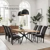 A dining room setting with a wooden table and chairs, illuminated by pendant lights. Náhled obrázku produktu