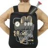 A person wearing a tan jacket is shown from the back, wearing a black backpack with a steampunk-inspired engine design. Náhled obrázku produktu