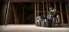 A person is kneeling and working with a toolbox in a construction site. Anteprima dell’immagine prodotto