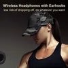 A woman wearing a camouflage baseball cap and a black tank top, with a blue earbud in her right ear, is shown from the chest up. She is holding a weight in her left hand. Náhled obrázku produktu