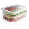 A multi-layered food storage container filled with ingredients for sandwiches. Produktbild-Vorschau