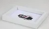 A white picture frame with a drawing of a woman inside, placed on a light gray surface. Produktbild-Vorschau