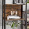 A close-up view of a bookshelf with books and decorative glasses. Produktbild-Vorschau