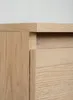 A close-up shot of the corner of a wooden cabinet, showing the grain of the wood and the edge of a drawer. Podgląd zdjęcia produktu
