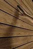 A hand touching a wooden wall. Produktbild-Vorschau