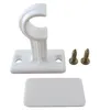 A white plastic curtain rod bracket with two screws and a decorative cover. Produktbild-Vorschau