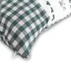 A close-up view of a green and white checkered pillowcase with a zipper. Produktbild-Vorschau
