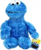 A plush toy of the Sesame Street character Cookie Monster is shown sitting against a white background. A small tag with an image of Cookie Monster is placed next to the toy. Produktbild-Vorschau
