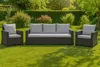 A set of outdoor furniture, including a sofa and two armchairs, placed on a green lawn in a garden setting. Anteprima dell’immagine prodotto