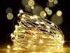 A close-up of a coiled string of warm white LED lights on a dark background with bokeh effects. Náhled obrázku produktu