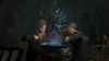 Two students in Hogwarts robes are brewing a potion in a large cauldron in a dimly lit room. Produktbild-Vorschau