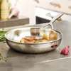 A stainless steel frying pan with food cooking inside, placed on a kitchen countertop. Anteprima dell’immagine prodotto