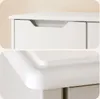 Close-up shots of a white dresser or cabinet, showing drawer details and rounded edges. Podgląd zdjęcia produktu