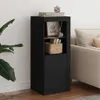A black sideboard with decorative items on top and a basket on the shelf, placed next to a sofa and a plant. Anteprima dell’immagine prodotto