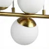 Close-up of a modern chandelier with glass globes and a gold-colored metal bar. Náhľad obrázku produktu