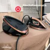 A steam ironing station and iron are placed on an ironing board. Produktbild-Vorschau
