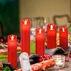 A table setting with red LED candles, Christmas crackers, and festive decorations. Produktbild-Vorschau