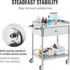 A stainless steel laboratory cart with various bottles and containers on its shelves and in its drawer. Produktbild-Vorschau