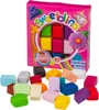 A box of edible sugar dough in various colors, with individual pieces of dough scattered in front of it. Produktbild-Vorschau