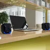 A laptop and two speakers are placed on a desk in front of a window. Náhľad obrázku produktu