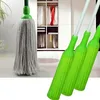 A close-up of a mop head and handles in front of a closet with clothes. Voir les images du produit