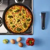 A cooked frittata in a pan on a stovetop, with ingredients laid out on a blue surface. Voir les images du produit
