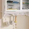 Detailansicht der SoBuy Wandvitrine FSB114-E-W: Kopfhörer und Schlüssel an Haken unterhalb des Schranks Voir les images du produit