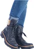 A pair of black lace-up boots with fur trim, worn with cuffed blue jeans. Anteprima dell’immagine prodotto