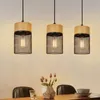 Three pendant lights hanging over a dining table. Anteprima dell’immagine prodotto