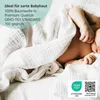 A baby wrapped in a white muslin cloth. Produktbild-Vorschau