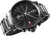 A close-up studio shot of a black Tommy Hilfiger watch with a metal band. Náhled obrázku produktu