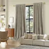 A living room scene with curtains, a sofa, and a chair. Produktbild-Vorschau