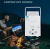 A couple is sitting by a campfire at night, with a portable water heater in the foreground. Voir les images du produit