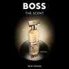 A bottle of Hugo Boss The Scent perfume is displayed on a reflective surface against a dark background with a spotlight effect. Anteprima dell’immagine prodotto