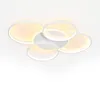 A modern, white, multi-ringed ceiling light fixture against a white background. Voir les images du produit