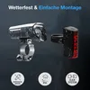 A set of bicycle lights, a front headlight and a rear taillight, are shown with water droplets on them, suggesting they are waterproof. Icons below highlight features. Náhled obrázku produktu