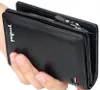 A hand holding a black wallet. Podgląd zdjęcia produktu