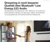 A couple dancing in a living room with a TV and soundbar in the background. Anteprima dell’immagine prodotto