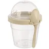 A clear studio shot of a single yogurt cup with a spoon attached. Voir les images du produit