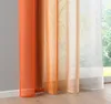 Close-up of sheer curtains with an orange gradient, hanging in front of a window with greenery visible outside. Produktbild-Vorschau