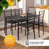 A dining set with a table and four chairs in a kitchen or dining room setting. Produktbild-Vorschau