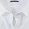 A close-up view of the collar and button placket of a white men's dress shirt. Produktbild-Vorschau