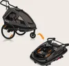 A child trailer in its unfolded and folded states, with an orange arrow indicating the folding process. Produktbild-Vorschau